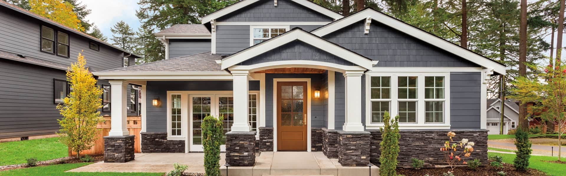 traditional home at night with a wood pella entry door in the front