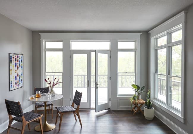 white french patio doors open to sunroom