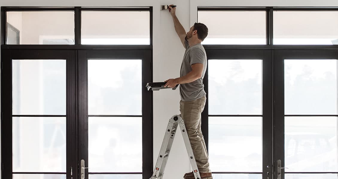 a do-it-yourselfer leveling a sliding patio door