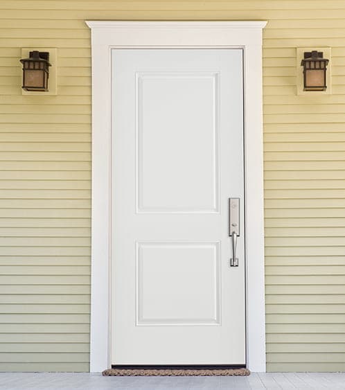 white solid steel front door on a yellow home exterior