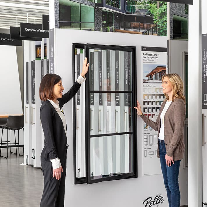 Expert showcasing a display in Pella showroom floor.