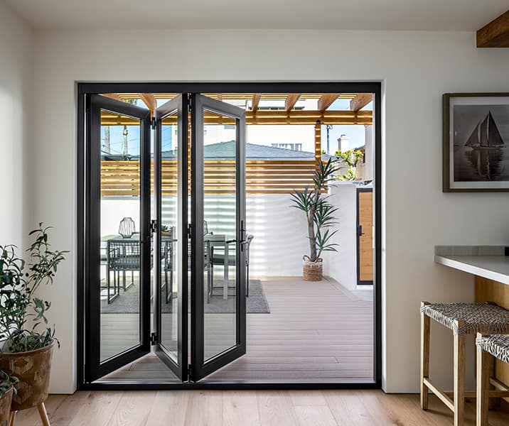 Open bifold doors from patio into a contemporary living room