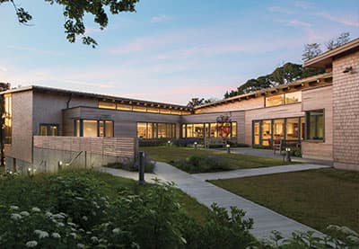 commercial building with light colored bricks and wood-clad windows