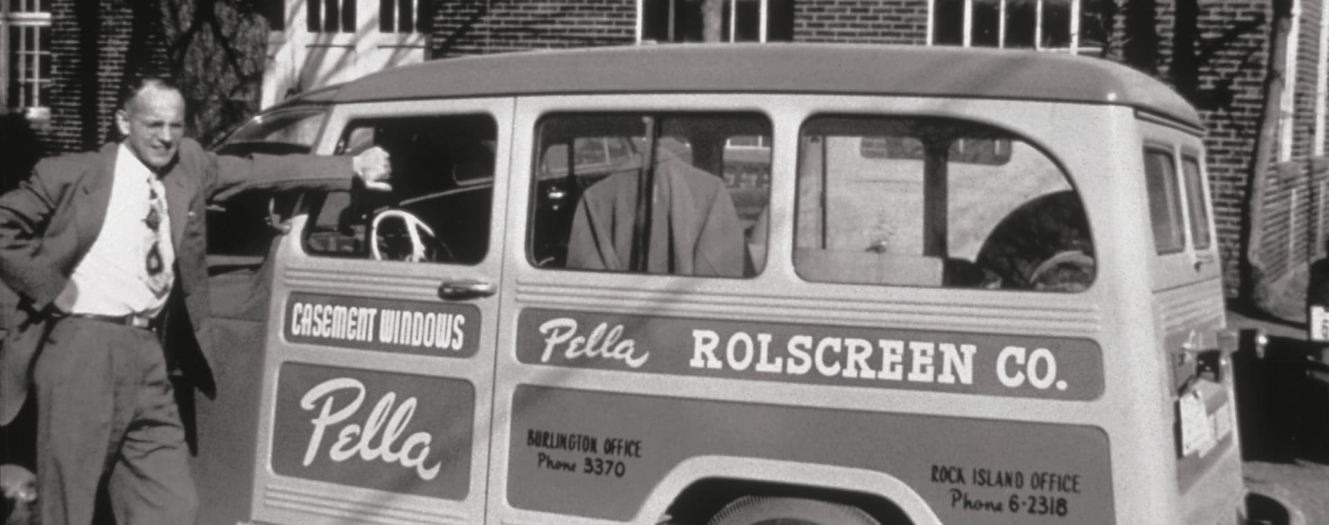 Pete Kuyper standing next to an original Pella delivery truck.
