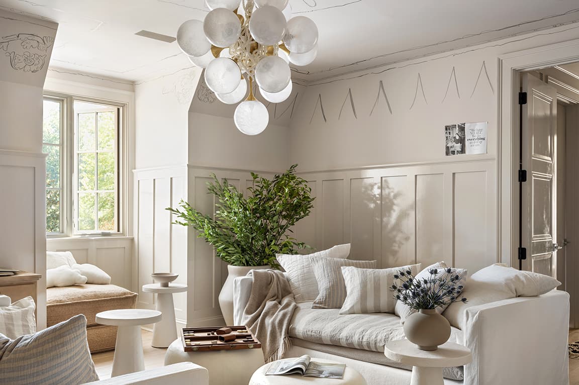 White casement windows featured in a cozy, neutral living room space.