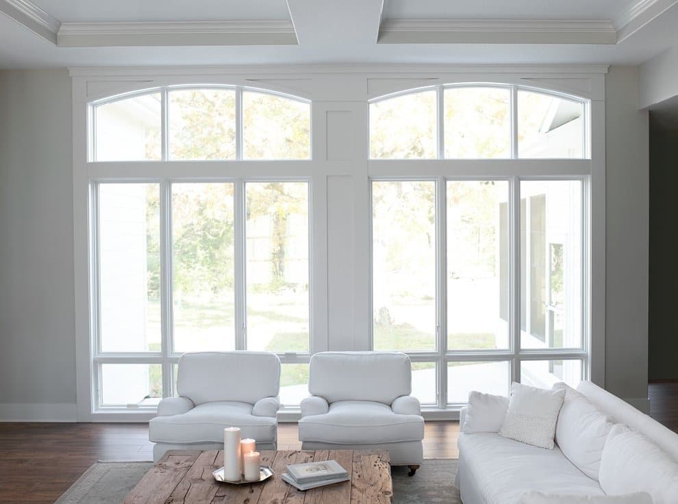 Floor To Ceiling Windows Let Light In & Keep Noise Out White living room with tall floor to ceiling special shape windows