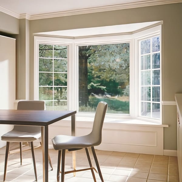 Small dinner table in a breakfast nook with a white bay window