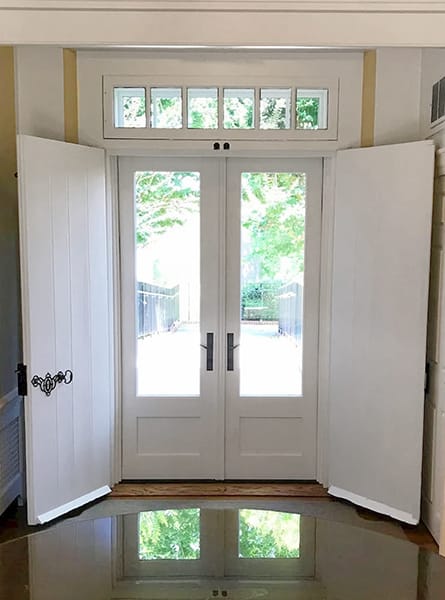 Interior image of a New Castle french door replacement highlighting a beautiful outdoor scene.