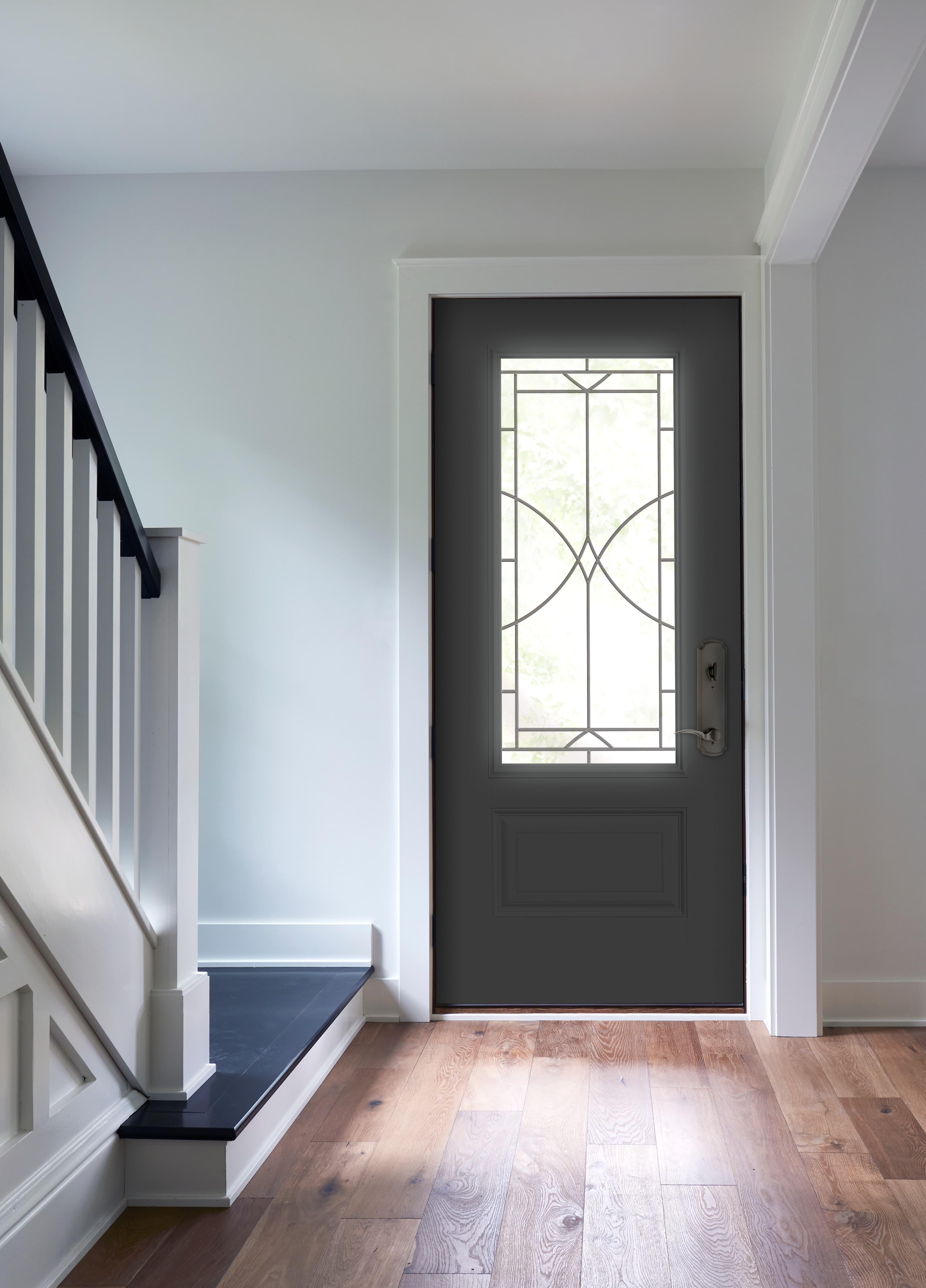 Black Front Door With Decorative Glass Illuminates Entryway Black entry door with decorative glass and white trim
